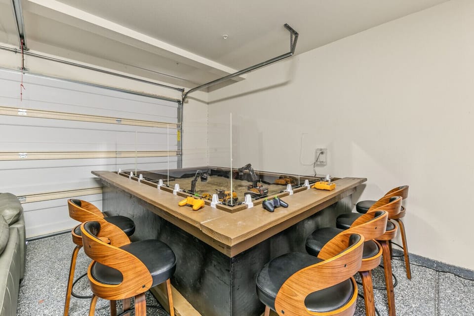 Gather around the custom-built indoor sandbox table, where guests of all ages can grab a controller and operate RC construction vehicles for unique, interactive entertainment!