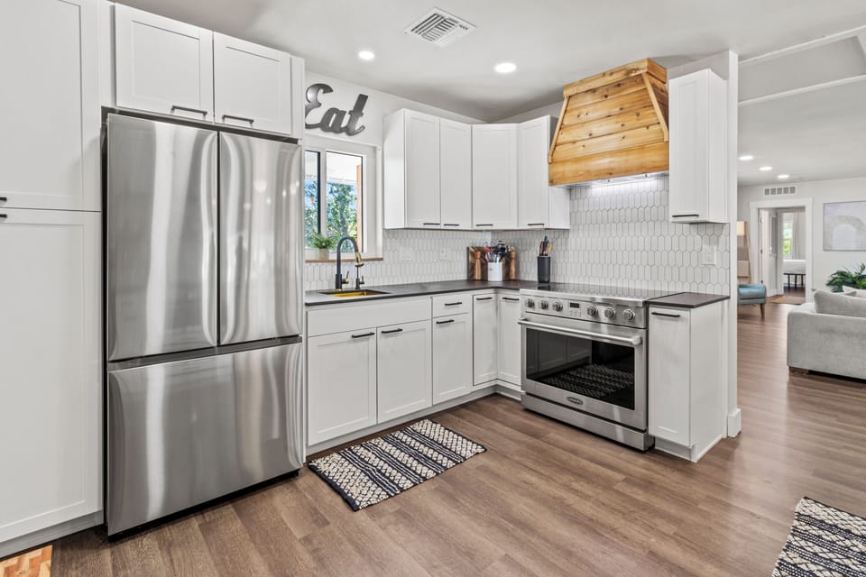 Chefs kitchen with custom cedar hood