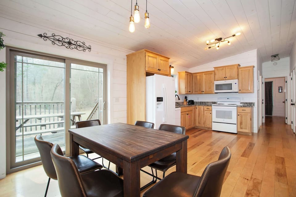 Share a meal in this bright, open dining area with modern seating and rustic wood accents.