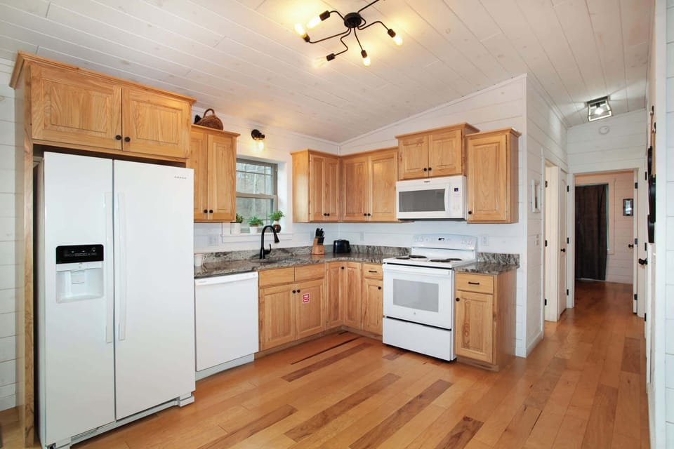 Whip up delicious meals in this fully equipped kitchen featuring granite countertops.