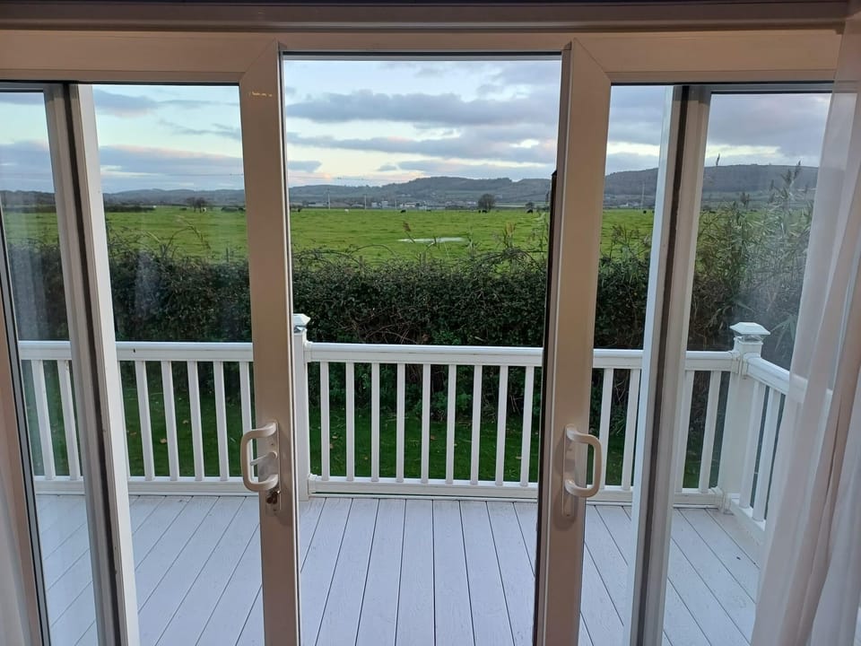 Relax and enjoy these beautiful field views from your private wraparound decking. With patio doors leading into the lounge you can find the perfect place to sit back and chill after a long day.