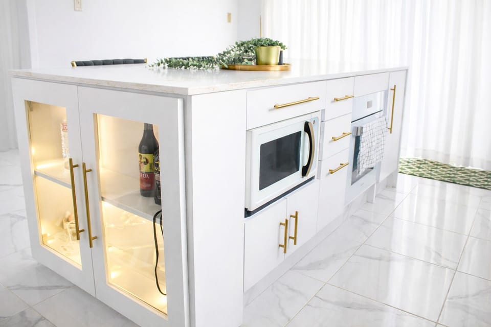 Bright modern kitchen with island seating, sleek finishes, and abundant natural light.