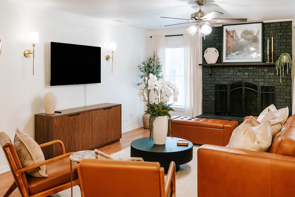 Open living area centered around cozy seating and a statement fireplace.