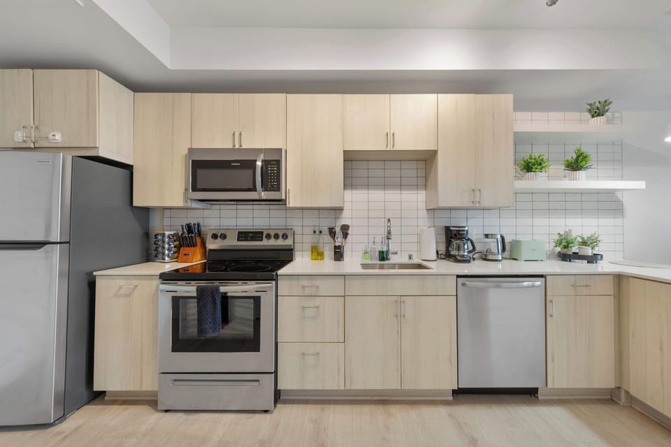 A fully equipped kitchen featuring modern appliances and sleek cabinetry. Whether you're preparing a gourmet meal or a quick snack, this kitchen is designed for functionality and style.