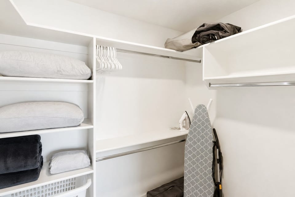Spacious walk-in closet with organized linens and handy guest storage