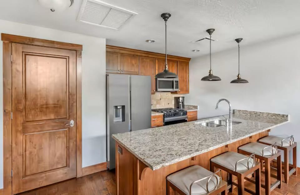 kitchen with bar seating. refrigerator dispenser filtered water and ice