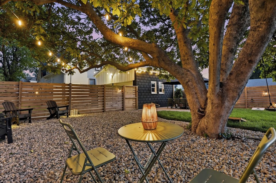 Enchanting backyard oasis with café lights and cozy evening seating