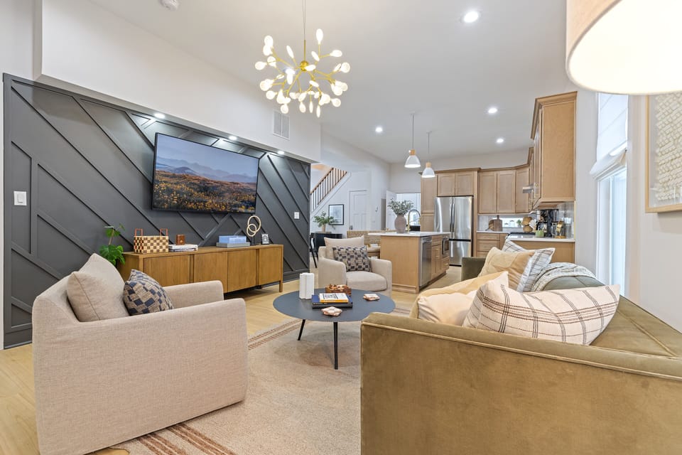 Kick back and relax in the living room! Enjoy comfy seating and a 65" smart TV.