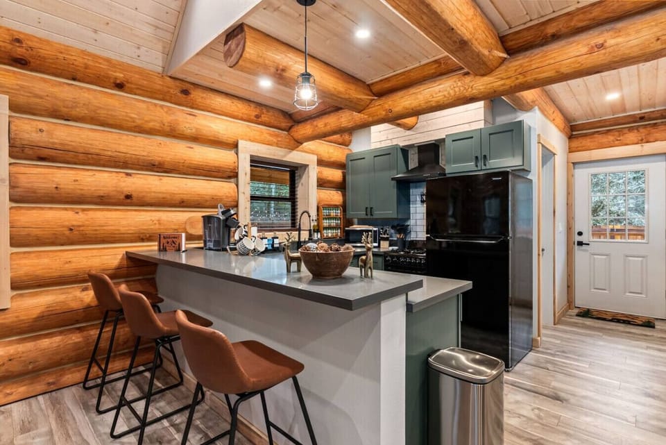 Bar seating with 3 chairs + dining table with 4 chairs - perfect for hearty breakfasts before hikes, cozy dinners by the fire, or morning coffee before hitting the trails!