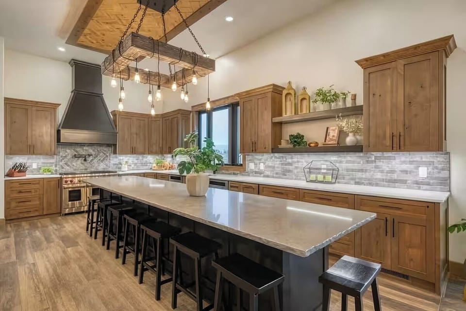 Spacious gourmet kitchen with large island, seating, and custom wood cabinetry.