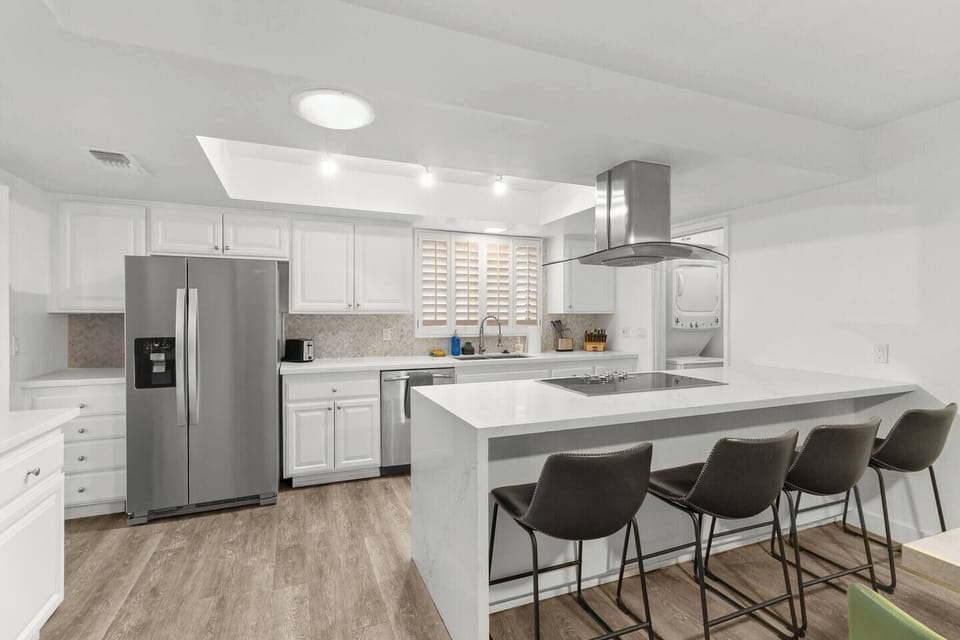 Fully equipped kitchen with modern appliances and ample prep space for home-cooked meals.