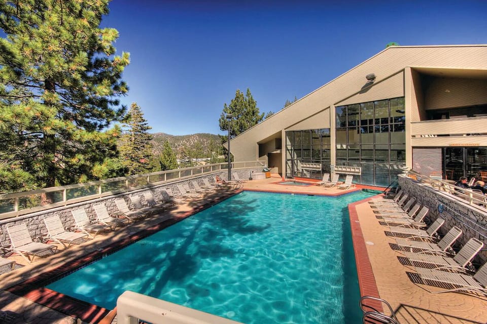 Soak under open skies while mountain views melt stress away.