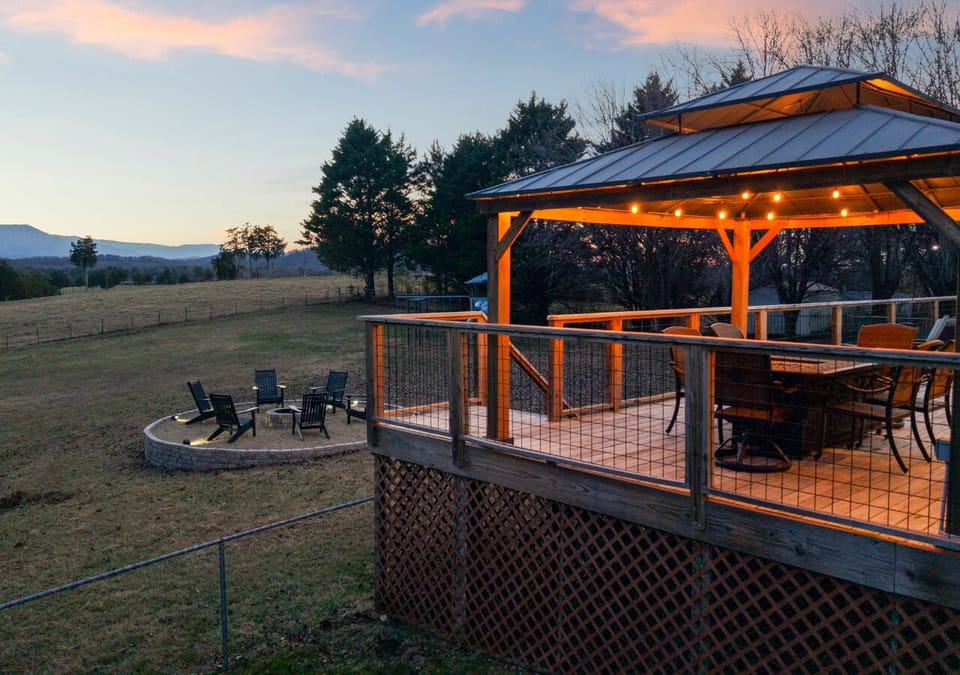Relax on the deck at twilight, enjoying the quiet mountain scenery as the sun sets.