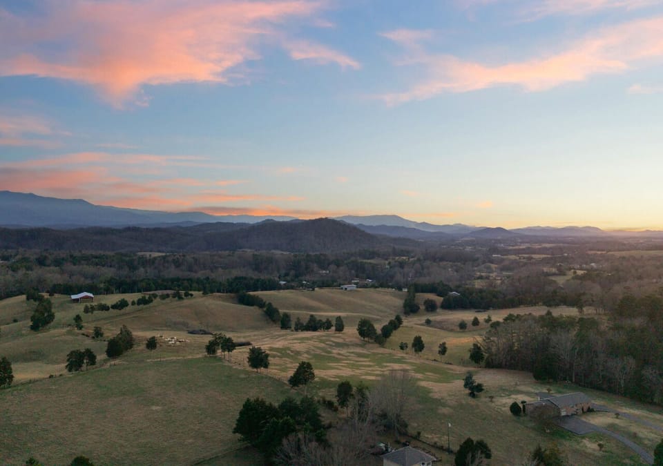 A stunning aerial twilight view, showcasing the cabin’s serene mountain surroundings.