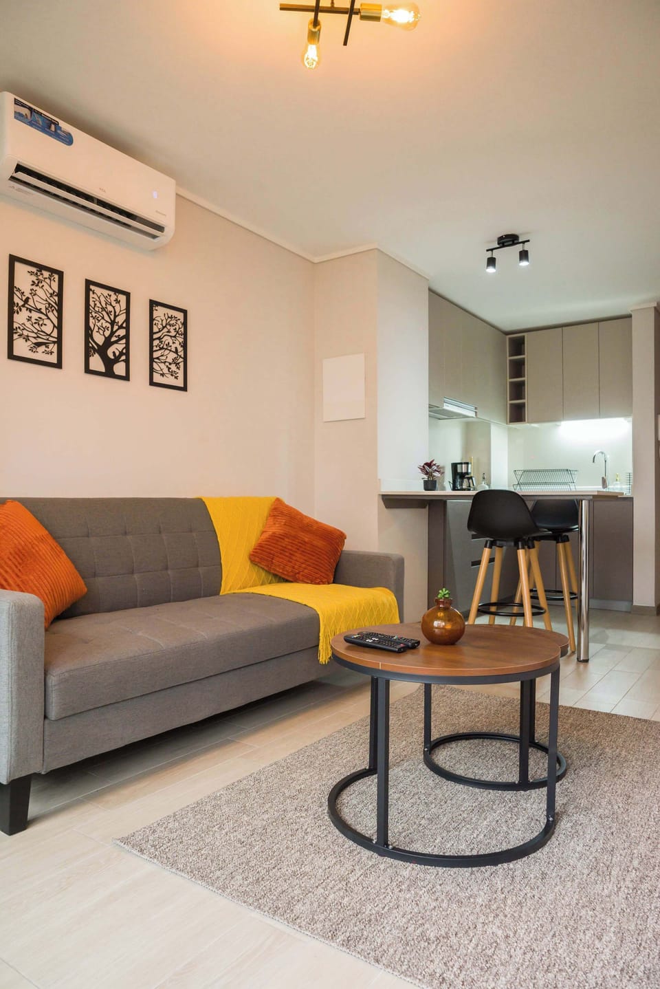 Relax in this stylish living area with modern decor and a convenient kitchen bar, perfect for unwinding after a day in the city.