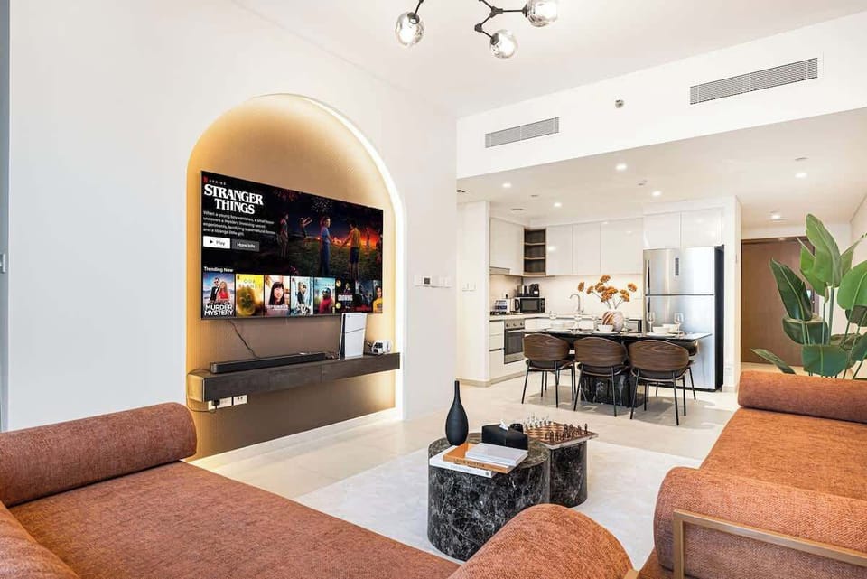 Warm, open-concept room with a full kitchen and elegant dining setup—made for memorable stays
