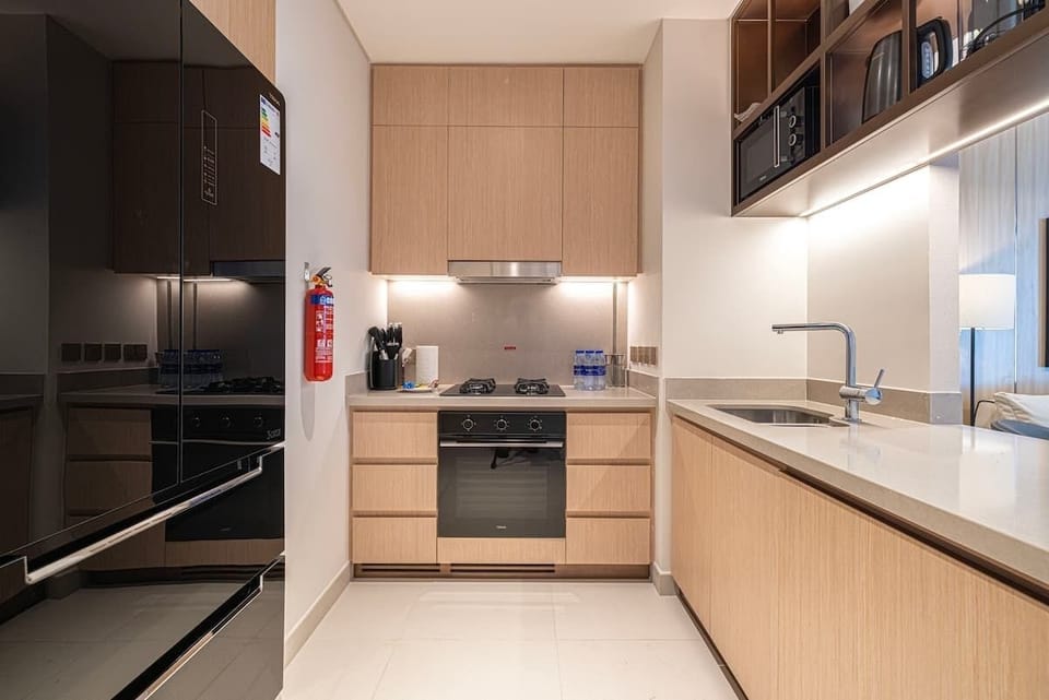 Fully equipped kitchen with modern appliances including a gas stove, oven, microwave, and toaster—perfect for preparing home-cooked meals during your stay.