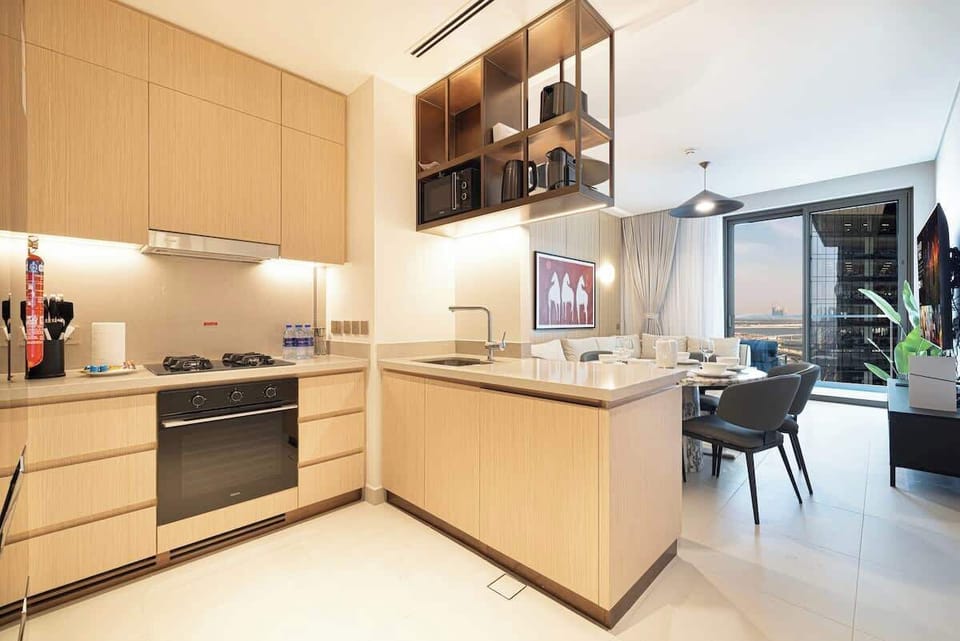 Inviting open-concept kitchen equipped for everyday cooking, with appliances and utensils included, and views into the dining and living areas