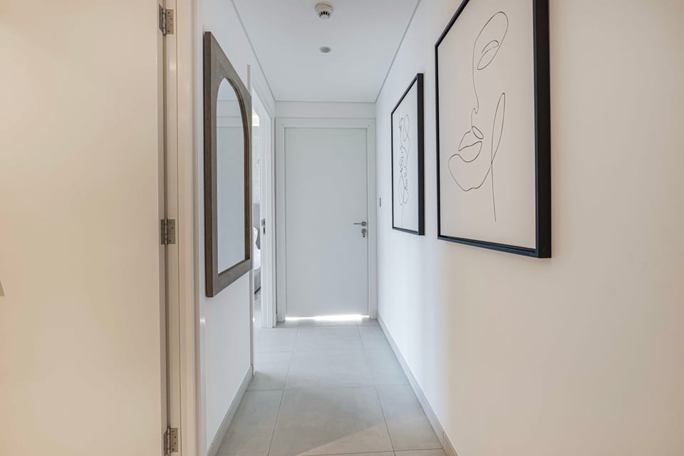 A hallway with simple art and soft lighting.
