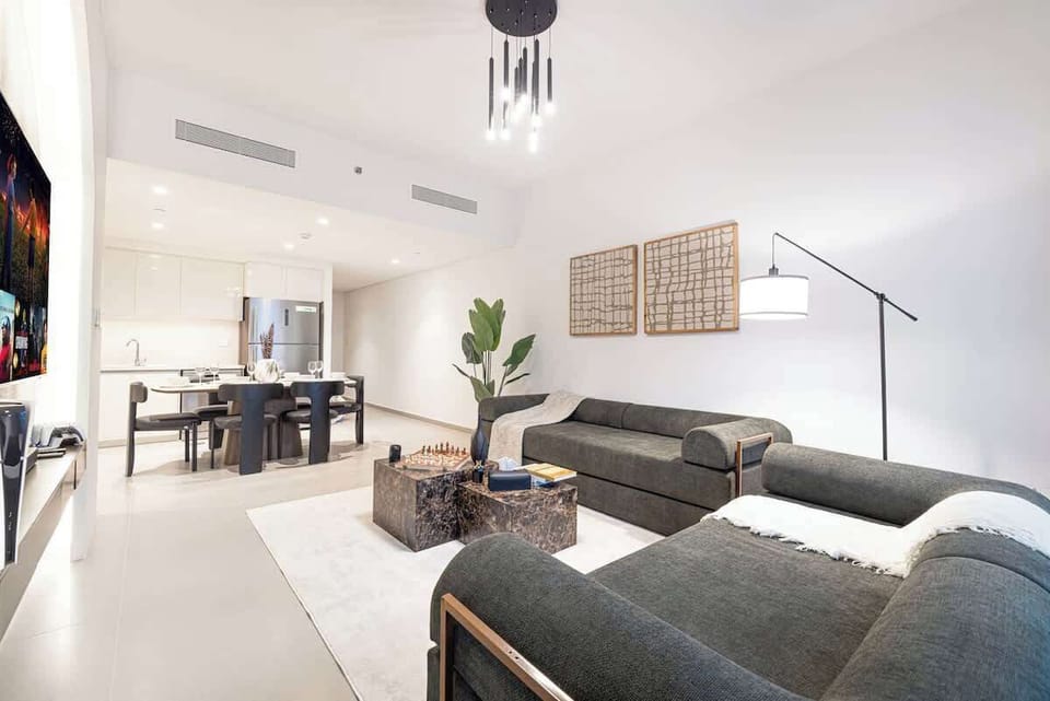 Warm, open-concept room with a full kitchen and elegant dining setup—made for memorable stays