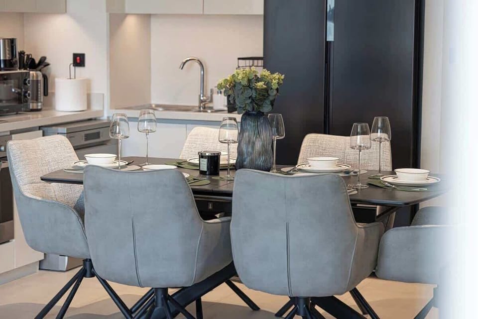 Share meals in the dining area while taking in living room views and the sparkling city skyline beyond large windows