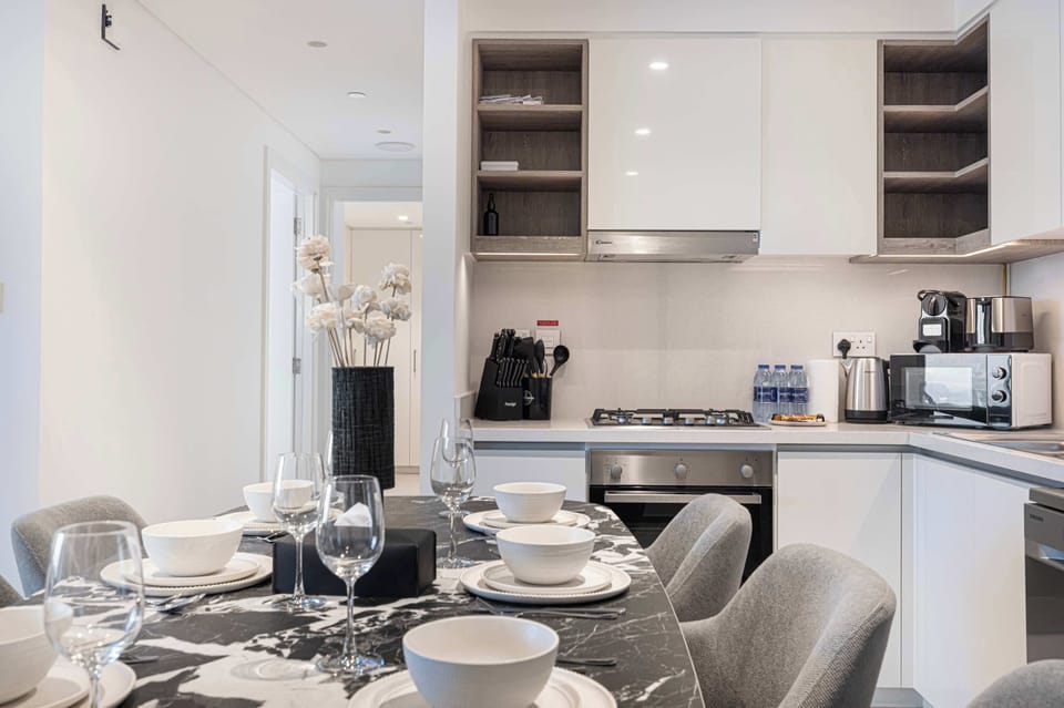 Modern kitchen featuring oven, stove, microwave, juicer, and all basic utensils
