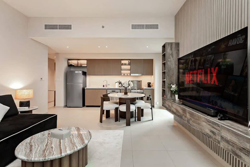 Elegant dining table ready for meals, perfectly positioned in an open space with living room access and panoramic city views