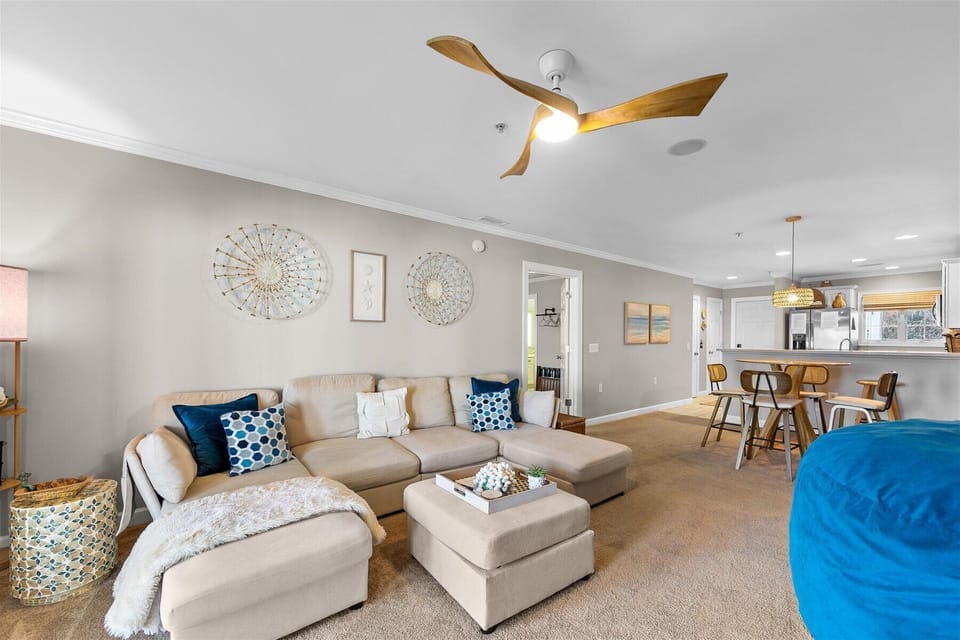 Relax in the bright, modern living space featuring a plush sectional sofa and open floor plan—perfect for unwinding after exploring.