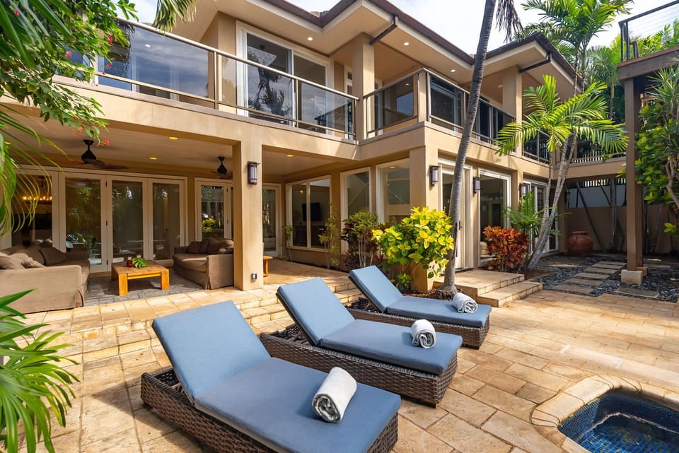 Unwind on your private poolside lanai with luxury loungers and towels, surrounded by tropical palms and elegant architecture.