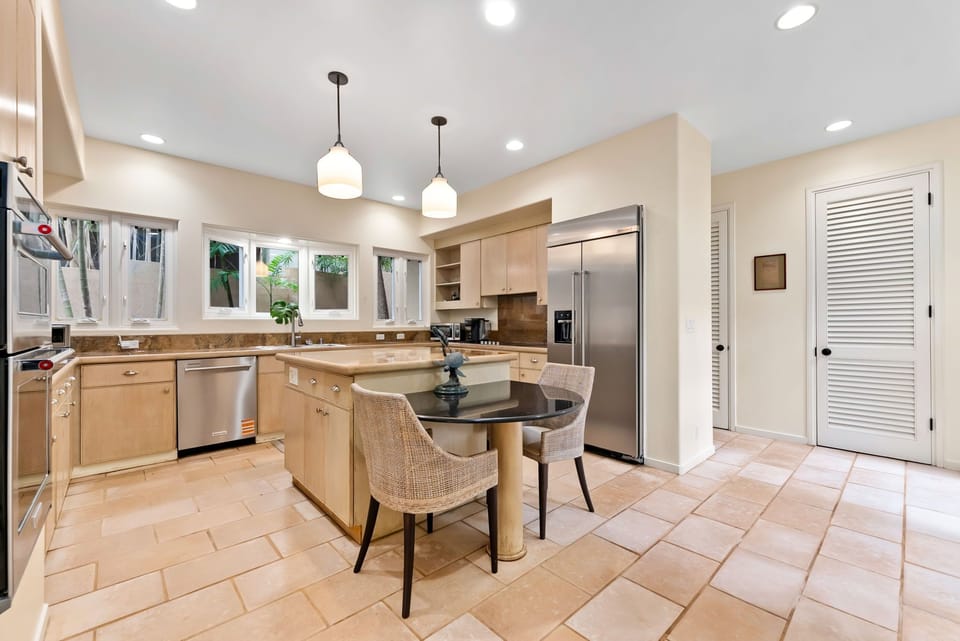 Your spacious gourmet kitchen awaits with gleaming appliances, granite counters, and a breakfast bar where you'll savor morning coffee.