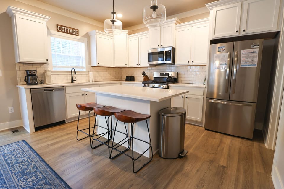 This bright, fully stocked kitchen makes cooking on vacation a breeze. Spacious center island with seating for three, stainless- steel appliances, and plenty of counter space for preparing meals or gathering with family.