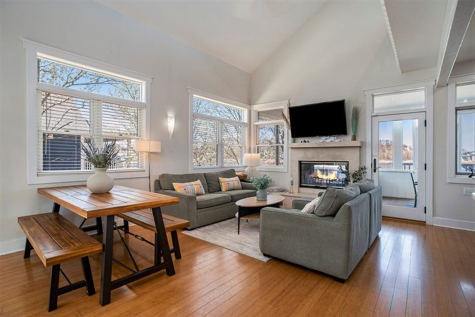 Open-concept living with vaulted ceilings and cozy couches.