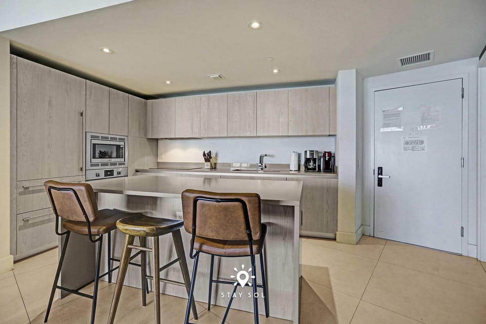 Fully equipped kitchen and isle—perfect for home-cooked meals.