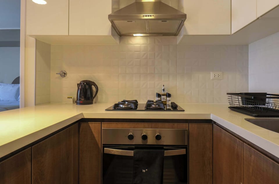 Fully equipped kitchen with modern appliances and clean, functional design.