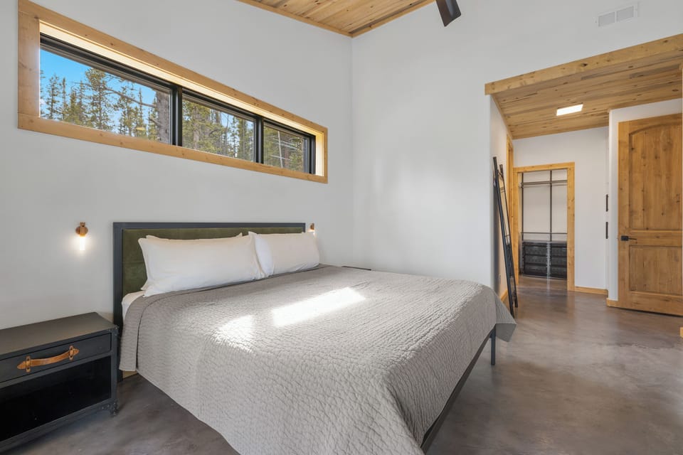 Has a spacious walk-in closet, a plush and comfy King size bed, a corner desk, a ceiling fan, sliding glass doors with access to the covered patio that runs the length of the home and an En Suite Bathroom.