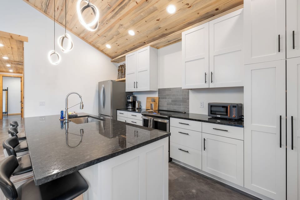 The kitchen offers plenty of counter space, top-of-the-line, stainless steel appliances, and is stocked with a great assortment of cooking, baking and dinnerware.