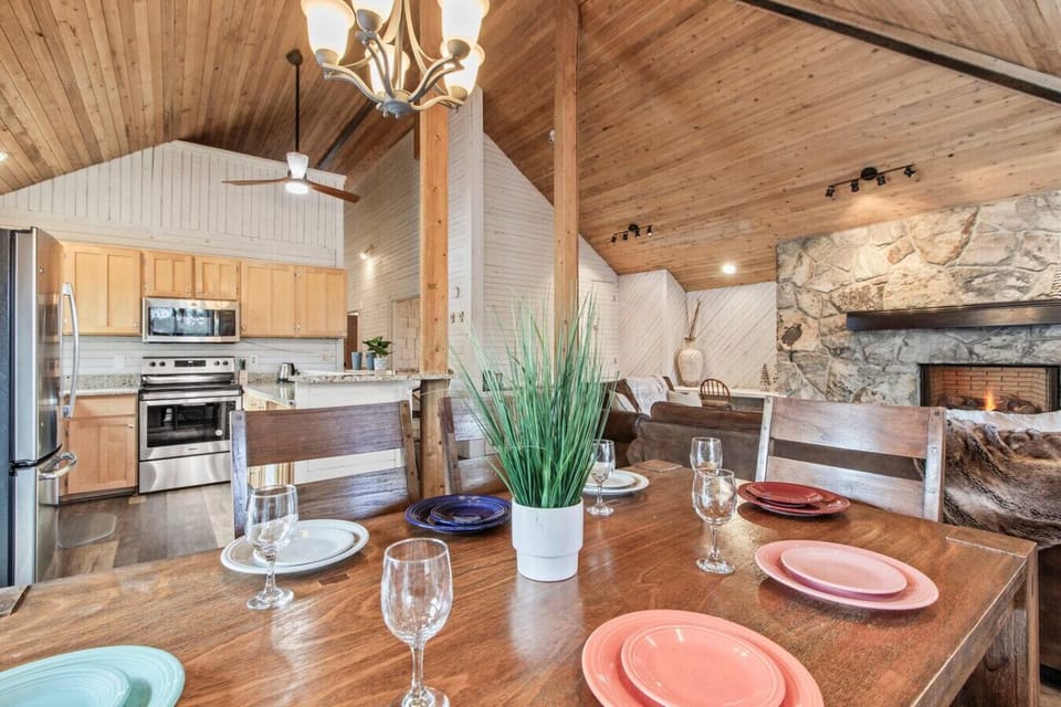 Kitchen area with table and breakfast bar area overlooking the large deck and pond