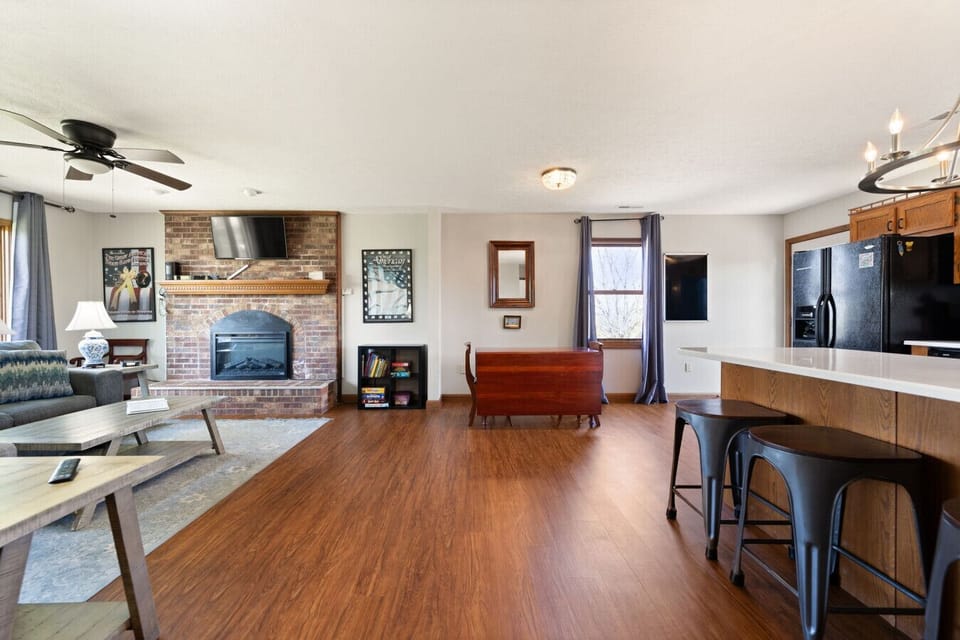 Living Room | Brick Fireplace | Smart TV & Hardwood Flooring