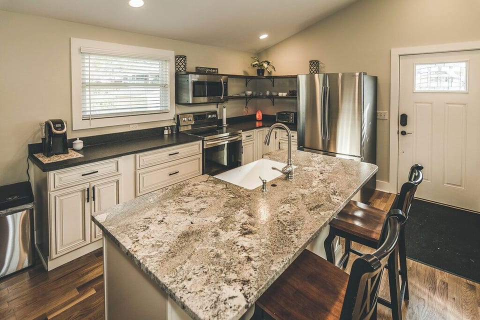 Granite island kitchen with seating, ideal for extended stays in Brevard NC