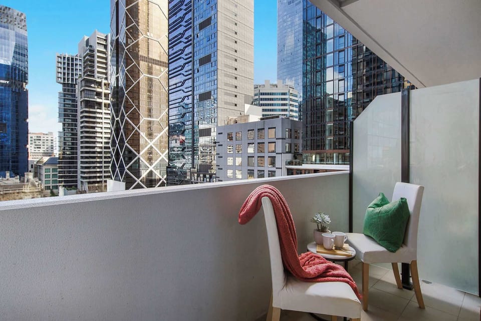 A private balcony with city views. *(Chairs in photo are from the dining area)