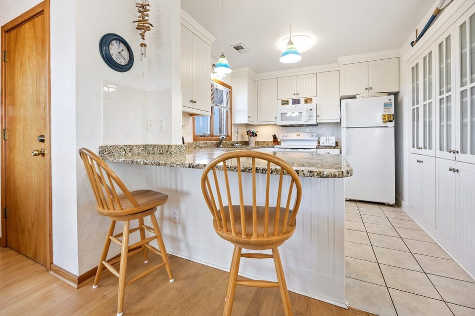 The breakfast bar offers casual seating for quick snacks or coffee.