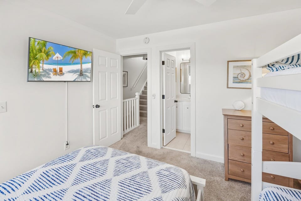 The second ensuite bedroom offers a Queen bed and a twin bunk set, making it ideal for families or additional guests.