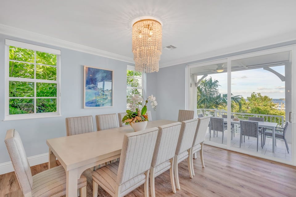 Bright dining space with seating for the whole group and views of the gulf and pool in this upscale Florida Keys rental.