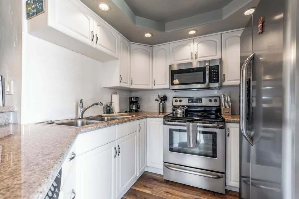 Fully equipped kitchen with fridge, freezer, dishwasher, microwave , and oven. 