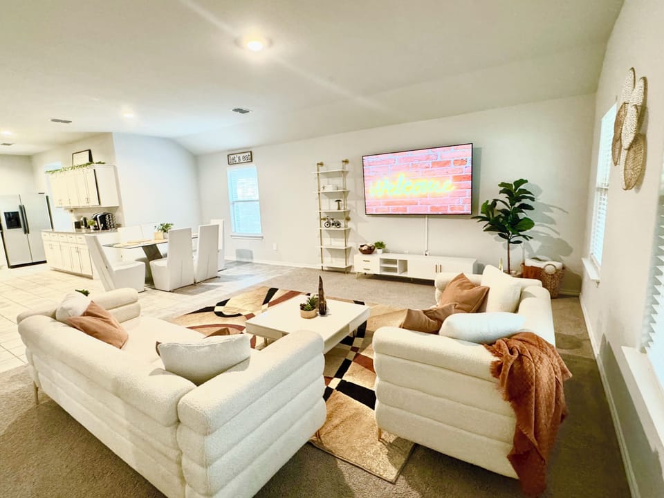 Cozy and spacious living room, comfortable seating, an open layout.