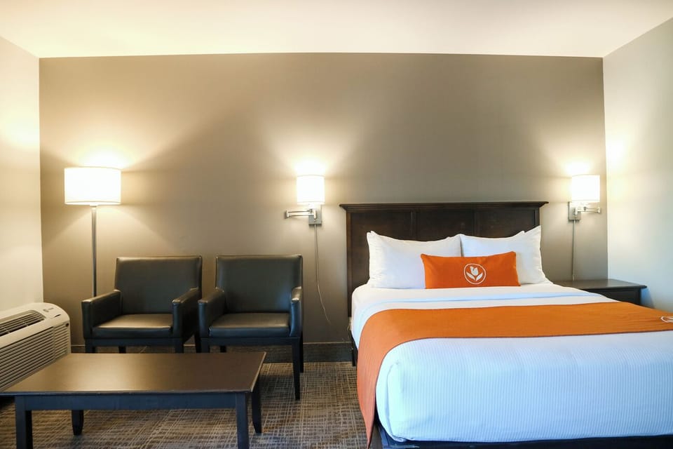 Unwind in a cozy room with seating and warm lighting.