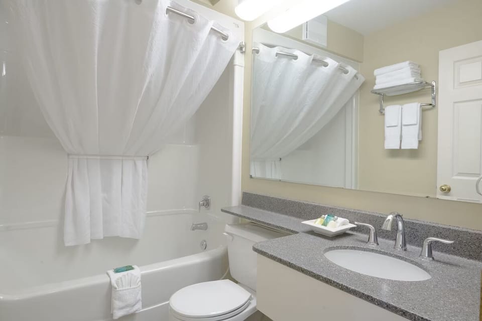 Refresh easily with a spotless tub-shower and bright vanity.