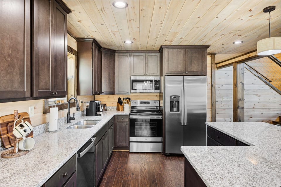 Fully equipped kitchen with stainless steel appliances and granite countertops.