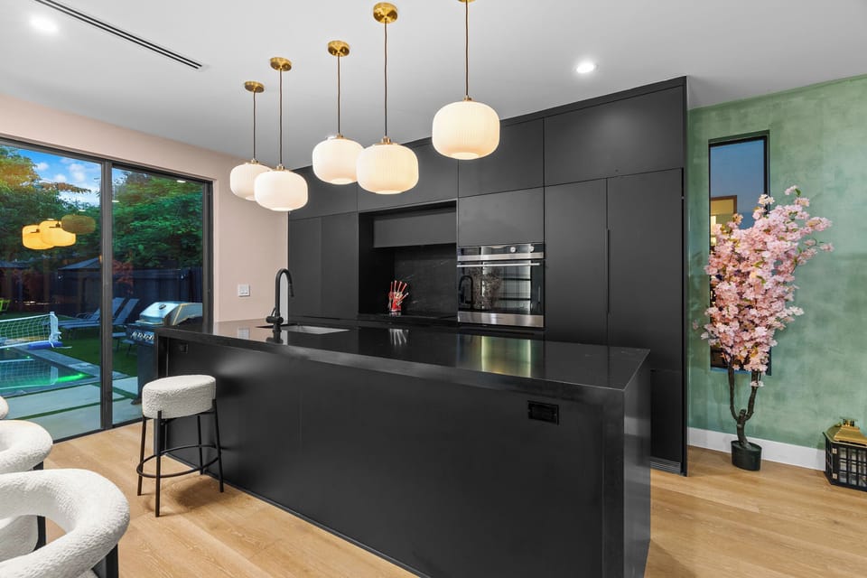 Fully equipped modern kitchen with sleek black finishes.