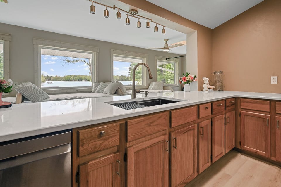 The kitchen is perfectly situated in the center of the upper level.  This allows for meals to be prepared while still allowing you to visit with your family and friends in the dining rooms or on the day beds.  